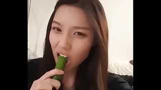 Asian Girl Sucks Cucumber